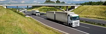 Trucks Driving Along an Asphalt Highway  
